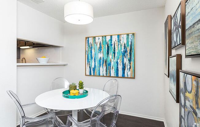 our apartments have a small dining room with a white table and chairs at Sunset Canyon, San Antonio, TX