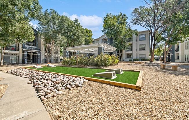 Outdoor Corn Hole Area at Allure North Dallas Apartments in Dallas, TX.