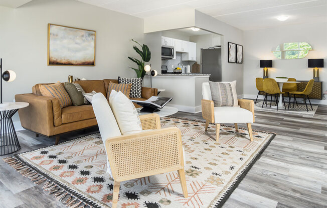 a living room with couches and chairs and a rug at The Heights Apartments, Cincinnati