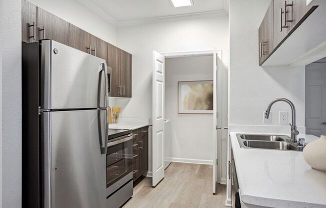 a kitchen with a refrigerator and a sink