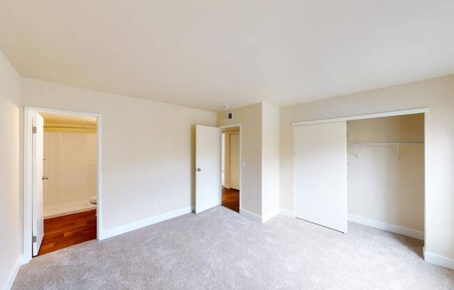 a bedroom with a carpeted floor and white walls