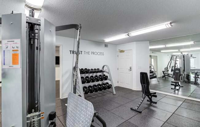 a fitness center with a treadmill and other exercise equipment