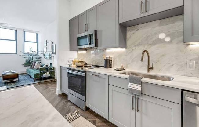 Premium finishes and fixtures include a matching quartz countertop and backsplash for a clean, modern look.