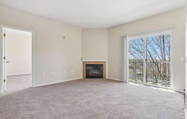A living room with a fireplace and a sliding glass door.