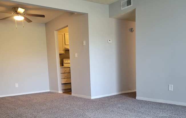 A wall with a grey texture and a ceiling with lights.