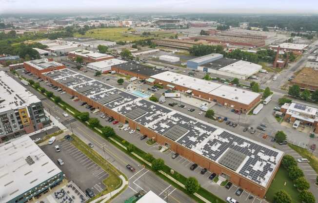 an aerial view of a parking lot and buildings in a city