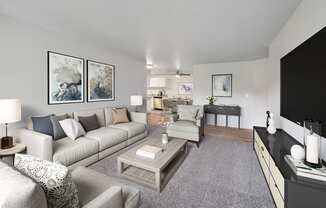 A living room with a grey carpet and a grey couch.