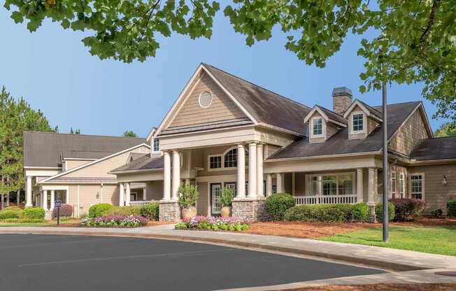 A large house with a grey roof and a chimney.