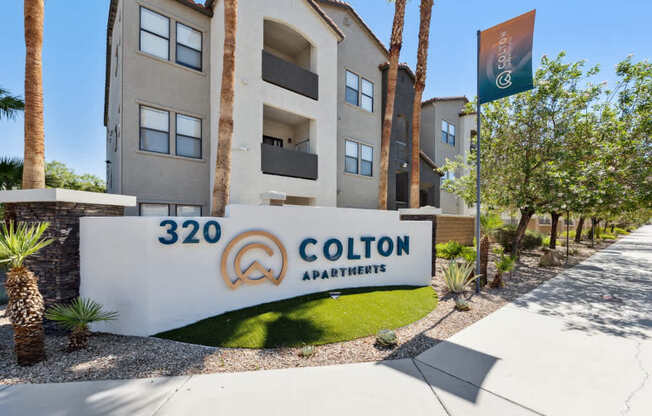 Colton Apartments building with a palm tree in front.