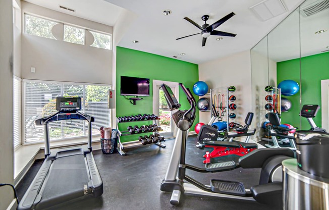 A room with a treadmill and exercise equipment at Beacon Ridge Apartments, PRG Real Estate Management, Greenville, 29615