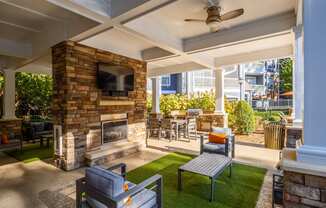 the preserve at ballantyne commons covered patio with fireplace and seating area