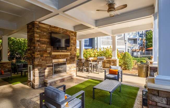 the preserve at ballantyne commons covered patio with fireplace and seating area