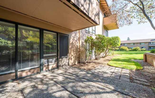 A sunny day at a residential area with a house and a tree.