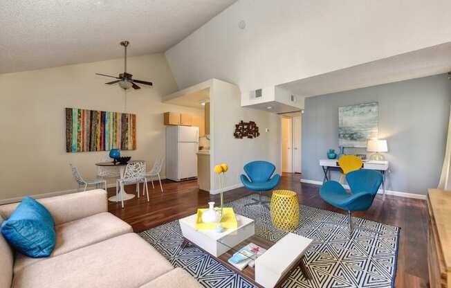 Model home living room and dining room with vaulted ceilings. 