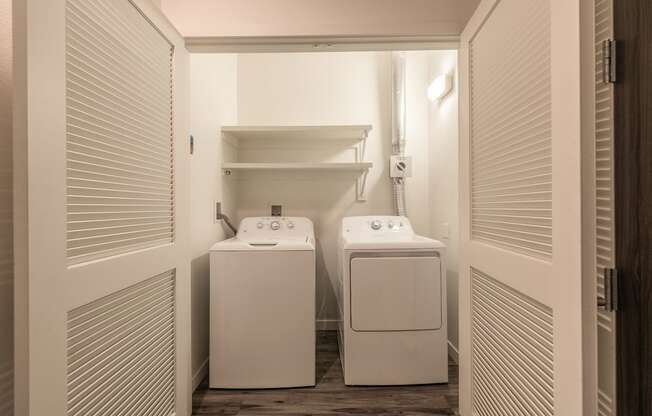 Laundry room in Live and Work apartment at 1400 FIG Apartments, Elegant bathroom with walk-in shower in a Live and Work apartment at 1400 FIG Apartments in Los Angeles, California.