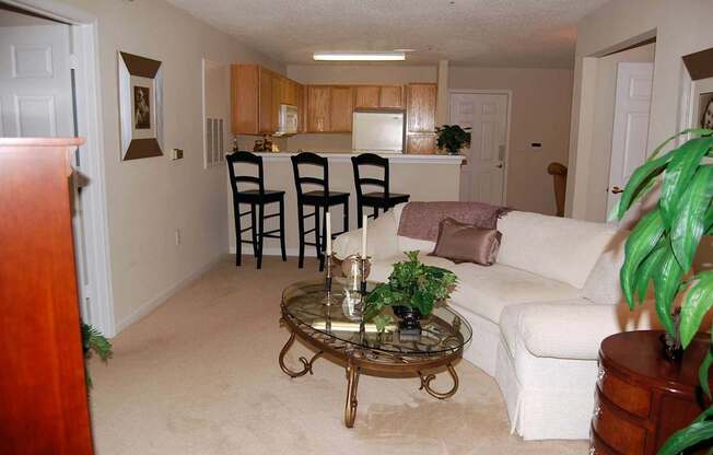 A living room with a white couch and a coffee table.
