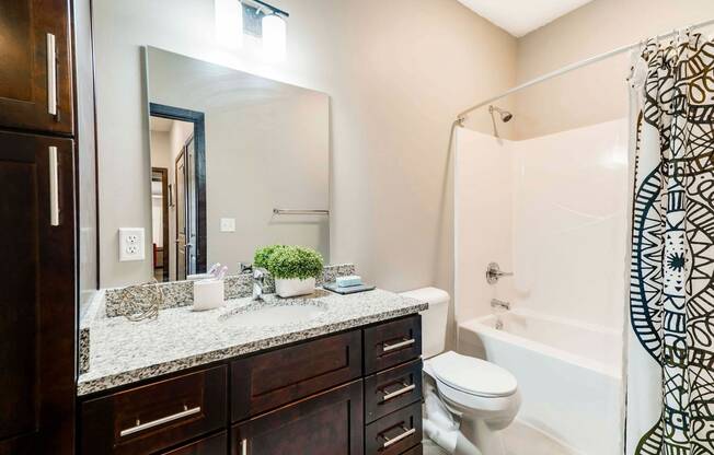 Spacious bathroom with tub shower and granite countertops in 2 bedroom apartment for rent at 360 at Jordan West best new apartments West Des Moines IA 50266