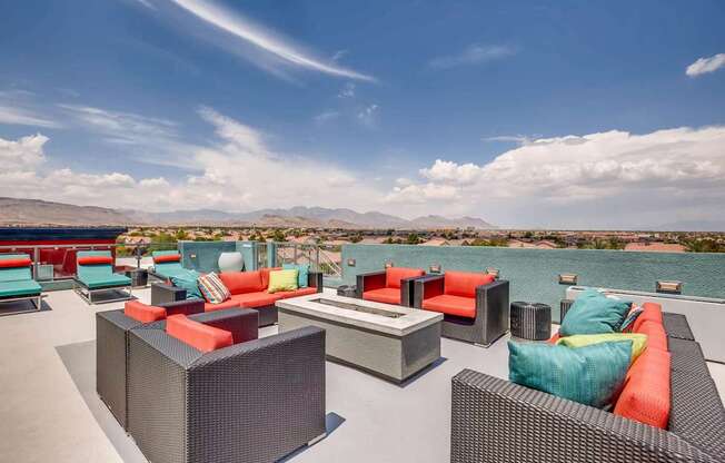 A patio with a table and chairs overlooking a body of water.