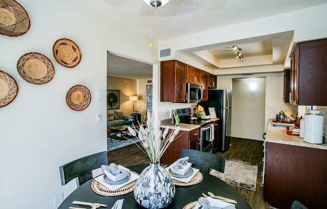 the view of the dining room and kitchen from the living room with the dining table