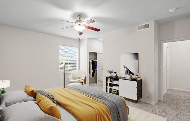 a bedroom with a bed and a ceiling fan