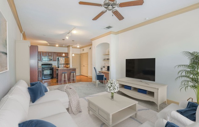 a living room with a white couch and a tv