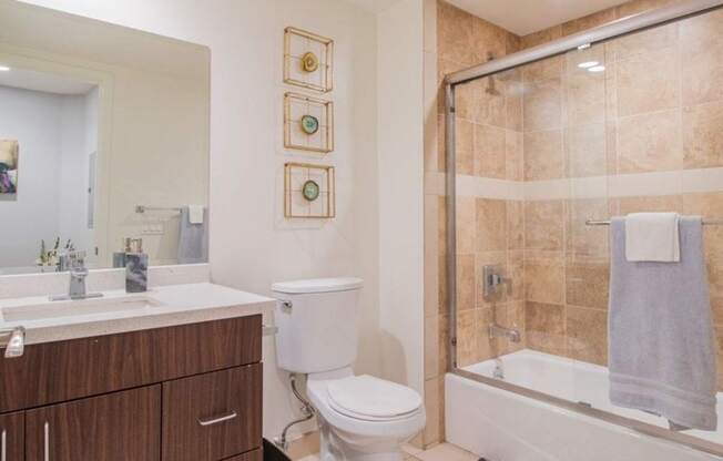 A bathroom with a toilet, sink, and shower at Woodley Sara Apartment, California