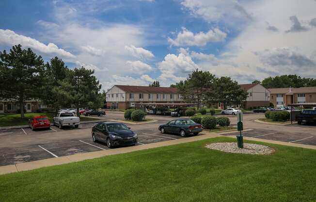 a parking lot with cars in front of a building at Village Club of Rochester Hills, Shelby Township Michigan