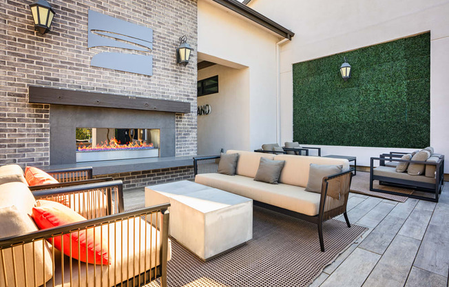 A patio with a fireplace and seating area.