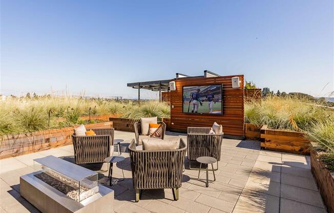 a patio with a tv and chairs