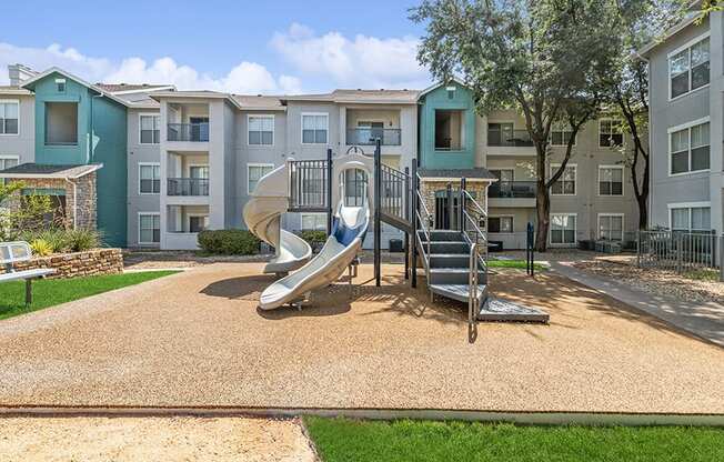 Community Playground with a Slide at Essence Apartments in Dallas, TX.