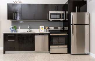 a kitchen with stainless steel appliances and black and white cabinets