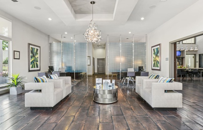 a living room with couches and chairs and a table