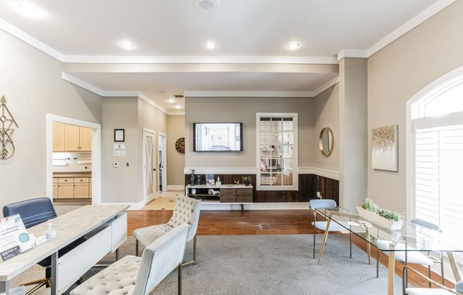 a living room with a dining room and a kitchen with a table and chairs