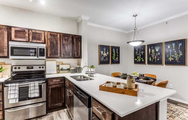 a kitchen with a large island and a stove and a sink