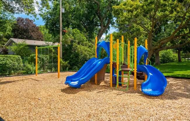 a playground with slides and a picnic table