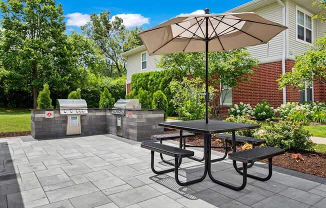 A patio with a table and chairs and a parking meter.