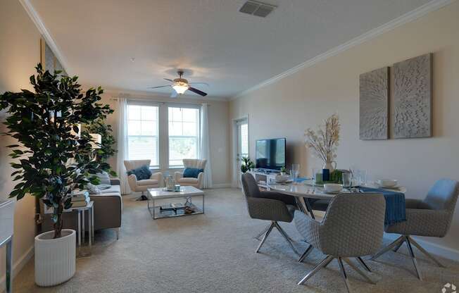 A living room with a dining table and chairs.