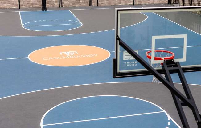 A basketball court with a hoop and a sign that says