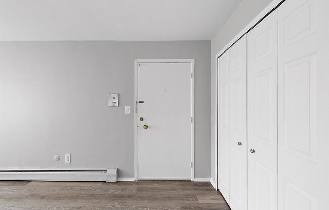 an empty room with white walls and a white door
