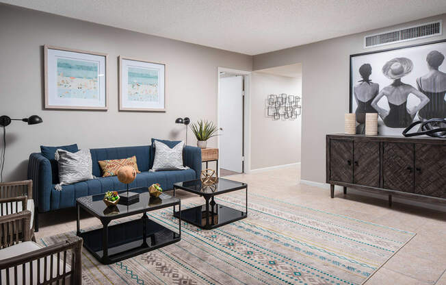 an open living room with a blue couch and a coffee table at Fairways of Inverrary, Florida