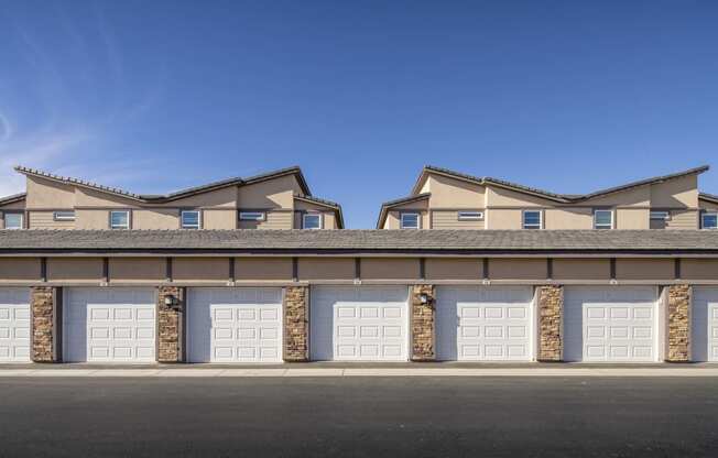 a building with several garages with white doors at Grandstone at Sunrise, Peoria, AZ