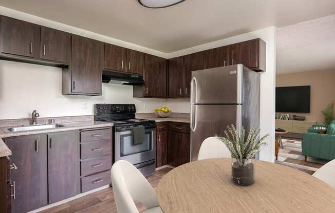 a kitchen with stainless steel appliances and a wooden table