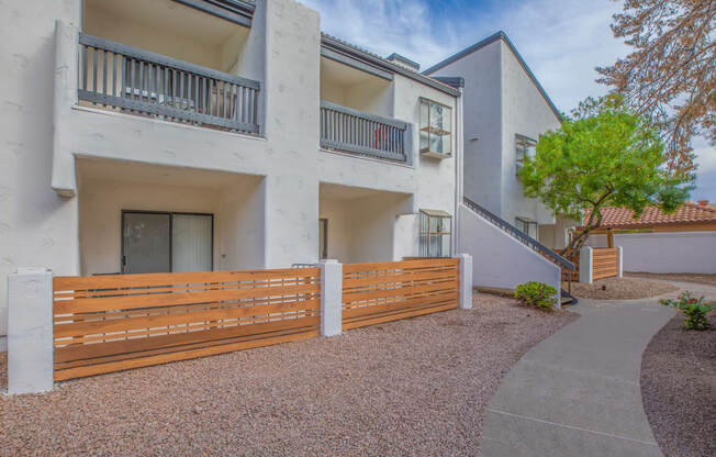 a white building with a wooden fence in front of it