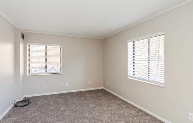 A room with a window and a hose on the floor.