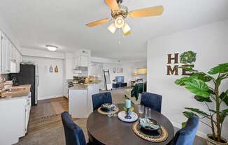 a living room with a dining table and a kitchen