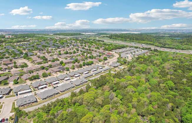 A bird's eye view of a residential area with houses surrounded by greenery.