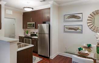 Kitchen with stainless steel appliances; open to dining room