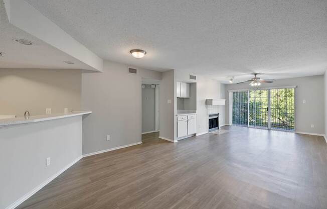 A spacious living room with a fireplace and sliding glass doors.