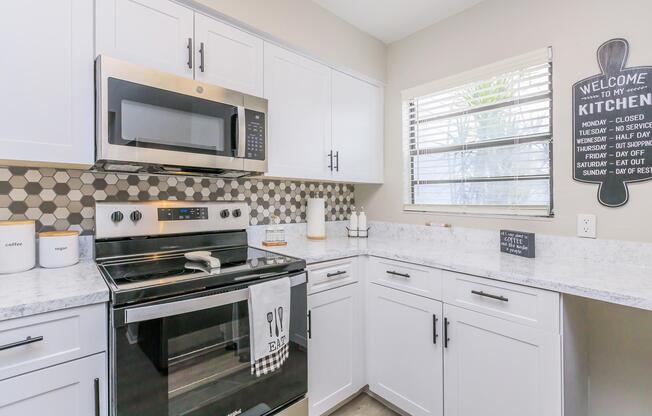 a stove top oven sitting inside of a kitchen