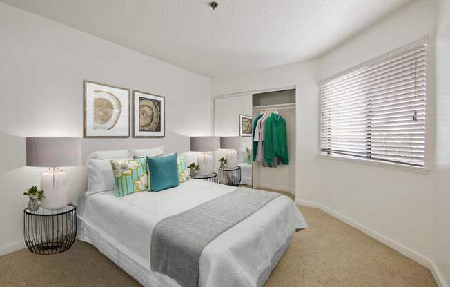 a bedroom with a large bed next to a window  at Masselin Park West, Los Angeles